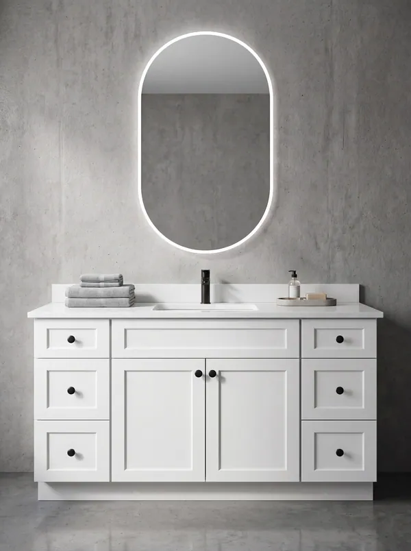 White vanity with lit mirror — Vita Cabinetry